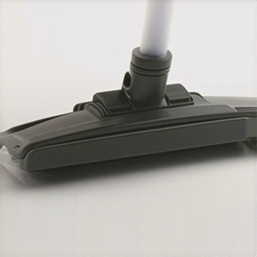 Close-up of a professional tool cleaning a linen sofa